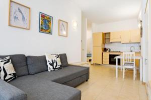 a living room with a couch and a kitchen at Fontanine House in Rapallo
