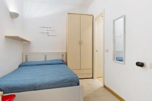 a small bedroom with a bed and a closet at Fontanine House in Rapallo