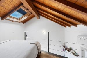 a bedroom with a white bed and a window at La Casa Di Lillo - Angera in Angera