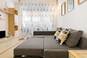 a living room with a couch and a television at Fontanine House in Rapallo