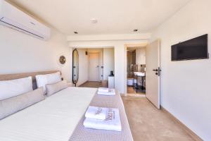 a living room with a couch and a tv on a wall at yazz inn in Kaş +57 photos