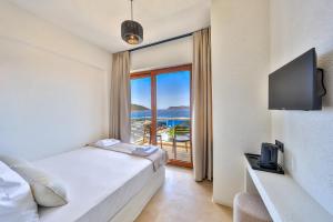 a bedroom with a bed and a view of the ocean at yazz inn in Kaş