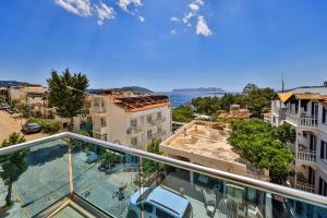 an apartment balcony with a view of a city at yazz inn in Kaş