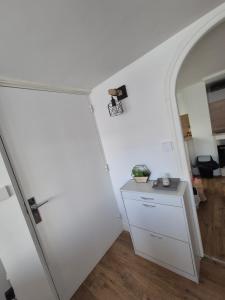 a white room with a white door and a table at Le cocon en ville in Limoux