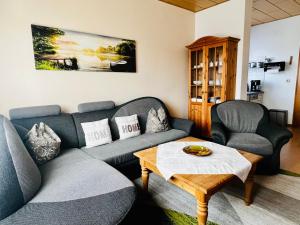 a living room with a couch and two chairs at Ferienwohnung "Meißner" in Rechlin