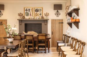 a dining room with a table and chairs at Ormesby Manor House & The Shepherds Huts & Well Lodge in Ormesby Saint Michael