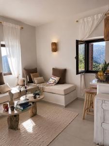 a living room with a couch and a table at Agrià XVII Mani Stone Tower in Kotráfion