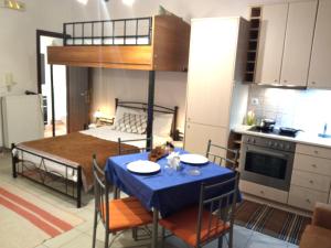 a kitchen and dining room with a table and a bed at Giannad suite in Distomo