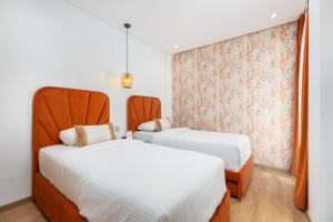 a bedroom with two beds and a window at Seaside Pool View 3BR Apt with 2 Balconies in Tangier