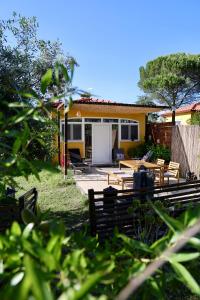 a house with tables and chairs in a yard at Quinta Ivonne in Montemor-o-Velho