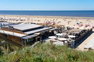a beach with a lot of people on the beach at The Sea Lodge in Zandvoort