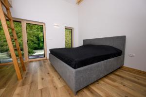 a bedroom with a large bed in a room at Cirus Riverfront Kolpa & Rafting in Kočevje