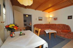 a living room with a couch and a table at Ruegen_Fewo 233 in Groß Zicker