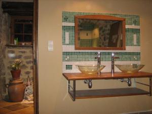 a bathroom with three bowls on a wall at La Ferme du Mont in Foissy