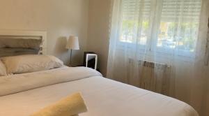 a bedroom with two beds and a window at Pisos Baraja Gl in Madrid