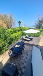 a patio with a table and chairs next to a pool at Casa Katarina Beach Apartment in Silvi Marina