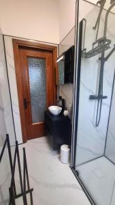 a bathroom with a toilet and a sink and a door at Casa Katarina Beach Apartment in Silvi Marina