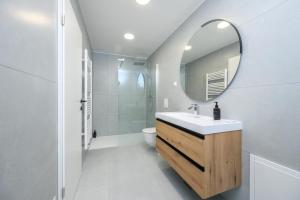 a bathroom with a sink and a mirror at Cirus Riverfront Kolpa & Rafting in Kočevje +23 photos