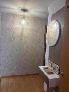 a bathroom with a wall with a mirror and a sink at Maresia in Burela de Cabo +20 photos