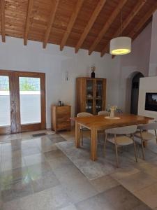 a dining room with a wooden table and chairs at Casinha Laranja in Monchique