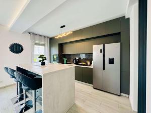 a kitchen with green cabinets and a white refrigerator at Joy City Stay Lavandei 2 in Timişoara +50 photos