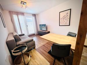 a living room with a couch and a chair at HOLZLODGE APARTMENTS - Alpine Living in Radstadt - Salzburger Sportwelt in Radstadt
