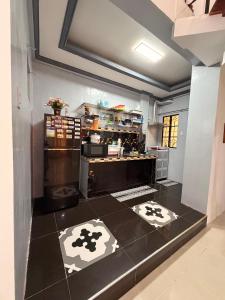 a kitchen with black and white tiles on the floor at Rose Haven Staycation Panabo in Panabo