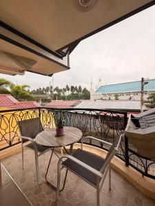 a patio with a table and chairs on a balcony at Rose Haven Staycation Panabo in Panabo