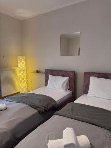 two beds sitting next to each other in a room at Krithia Apartment with Garden Family Apartment in Krithiá