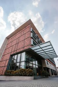a large building with a red brick at E.05 City Inn in Alwaye