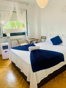 a bedroom with two beds and a window at Pisos Baraja Gl in Madrid