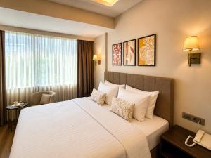 a hotel room with a large bed and a window at The Tram Karakoy in Istanbul