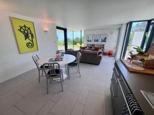 a kitchen and living room with a table and chairs at The Seahorse Torbay in Torquay