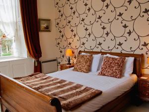 a bedroom with a bed and a wall with patterns at Foulston Apt- Cv12 in Liskeard +17 photos