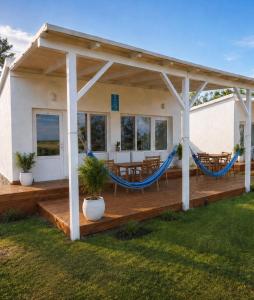 a deck with a hammock on a house at KRAPEC Beach in Krapets