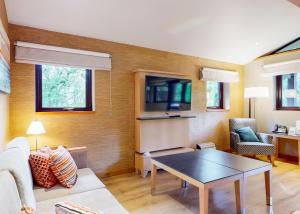 a living room with a couch and a table at Brockwood Hall Lodges in Silecroft