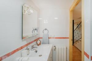 a bathroom with a sink and a mirror at Casa Romo 1 in Chavida +29 photos