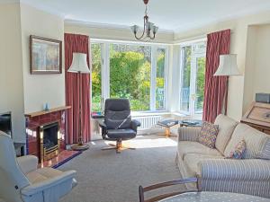 a living room with a couch and a chair at Belgravia Cottage in Skipton