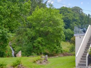 a view of a garden with a staircase and trees at Gamekeepers Apt - Cv20 in Liskeard +16 photos