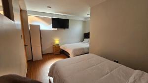 a hotel room with two beds and a television at Pumaexplorer in Urubamba