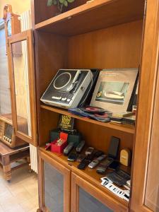a cabinet with a bunch of items in it at B&B Ducato delle Seimiglia in Camaiore