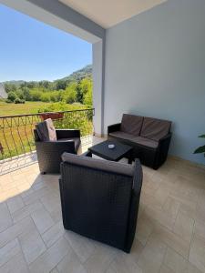 a patio with two chairs and a couch and a table at B&B Ducato delle Seimiglia in Camaiore