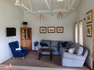 a living room with a couch and two chairs at Serena Cottage in Nottingham Road
