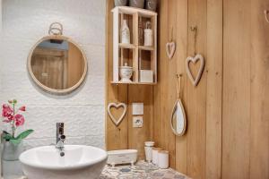 a bathroom with a sink and a mirror at Le Mas de la Rode in Saumane +50 photos