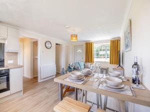 a kitchen and living room with a table and chairs at Oaks - Uk47372 in Burgh le Marsh