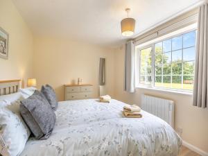 a bedroom with a bed and a window at Oaks - Uk47372 in Burgh le Marsh