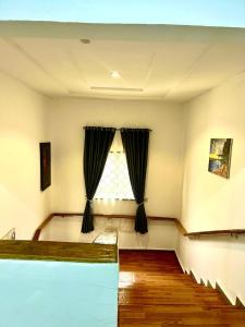an empty room with a window and wooden floors at Stylish Studio Near Jabi Mall in Gwarinpa