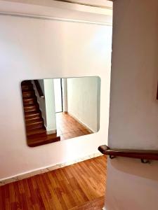 a mirror on a wall in a room with stairs at Stylish Studio Near Jabi Mall in Gwarinpa +1 photo
