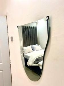 a mirror reflection of a bed in a bedroom at Stylish Studio Near Jabi Mall in Gwarinpa