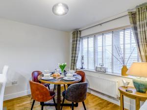 a dining room with a table and chairs and a window at Popleys in Helmsley
